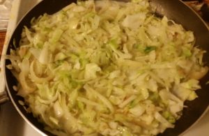 sautéed vegetables in a pan with milk added