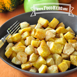 Bowl of baked apples and squash with a fork