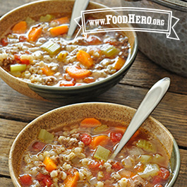 2 bowls of beef barley soup with spoons