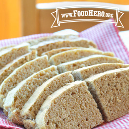 sliced whole wheat quick bread on a red and white checked napkin