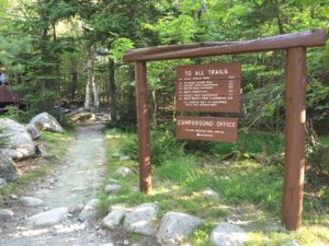 scenic campground sign with a hiking path