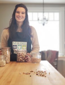 trained Nutrition Educator from Maine SNAP-Ed smiling in a kitchen with dried beans