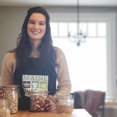 Staff member Madeline wearing Maine Snap-Ed apron