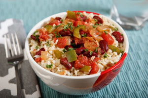 bowl of red beans and rice with napkin and fork