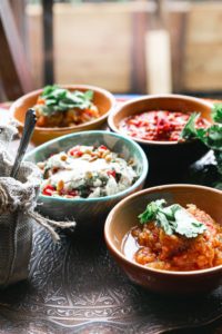 four bowls with different kinds of recipes using dried beans
