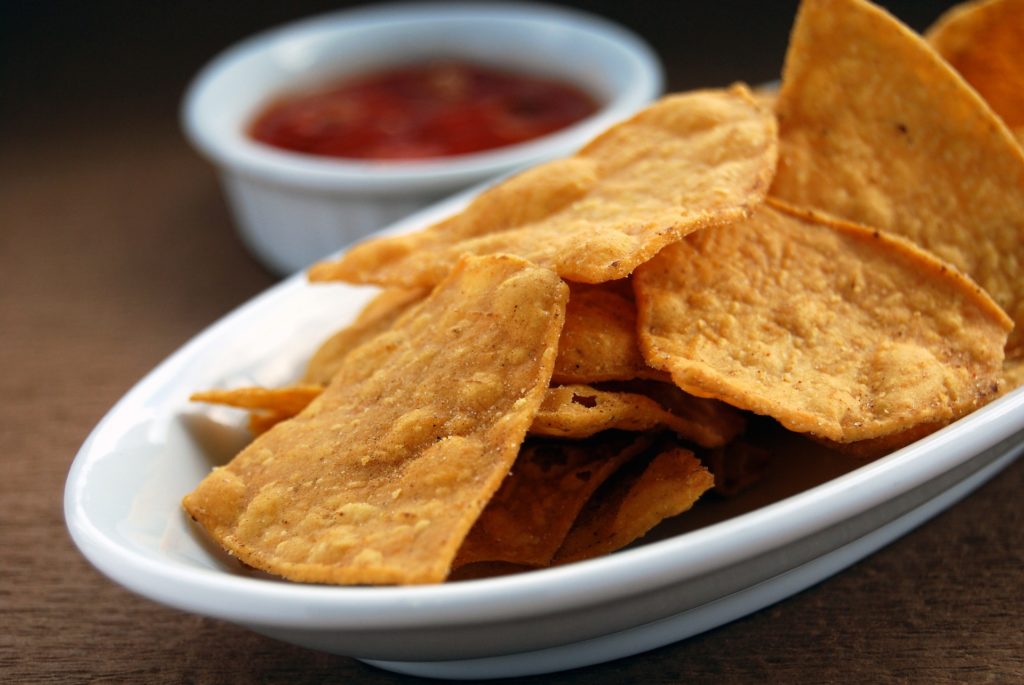 close up of tortilla chips with salsa