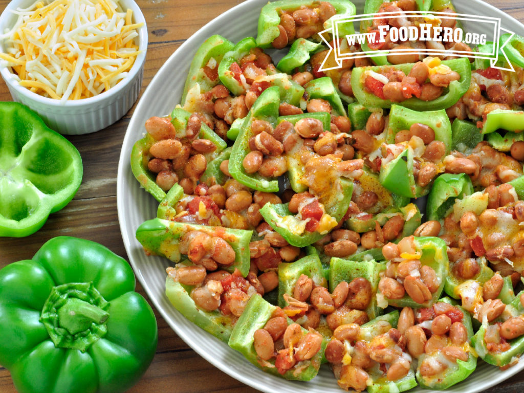 plate of bell pepper nachos with fresh peppers and a small bowl of shredded cheese