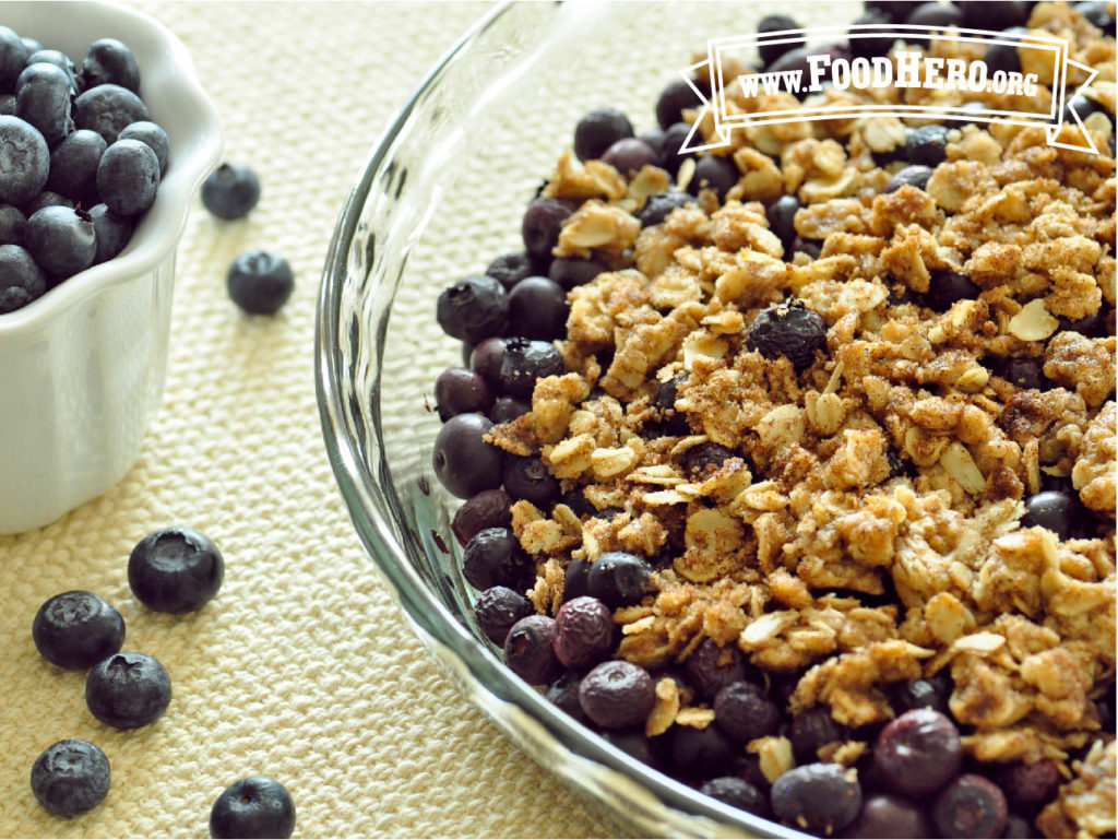 bowl of blueberry bling next to a bowl of fresh blueberries