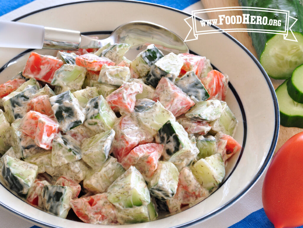 bowl of cucumber and tomato salad with spoon