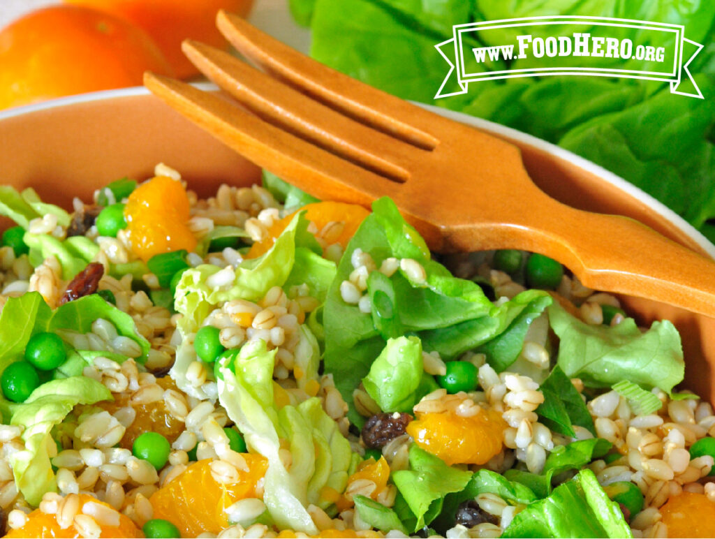 close up of fiesta barley salad with wooden serving fork