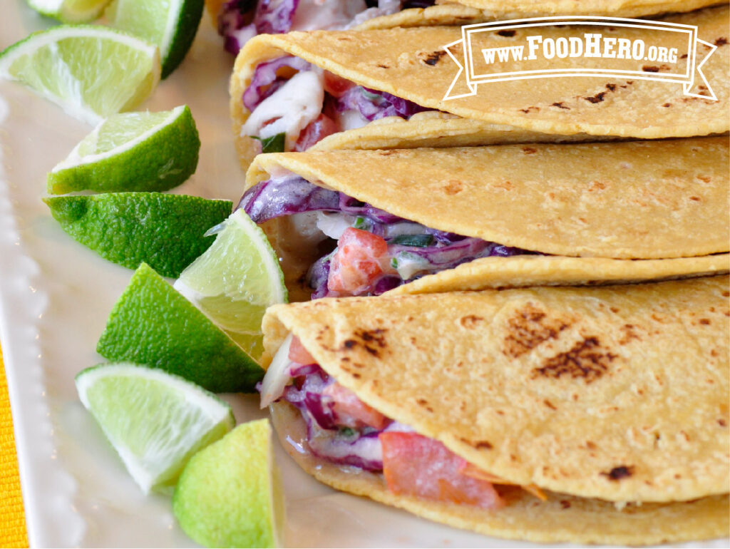 serving plate of fish tacos with cut lime