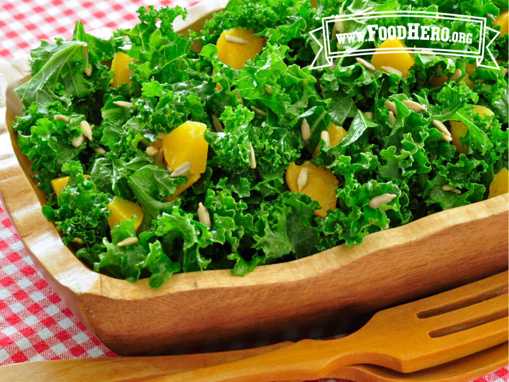 wooden salad bowl filled with kale salad