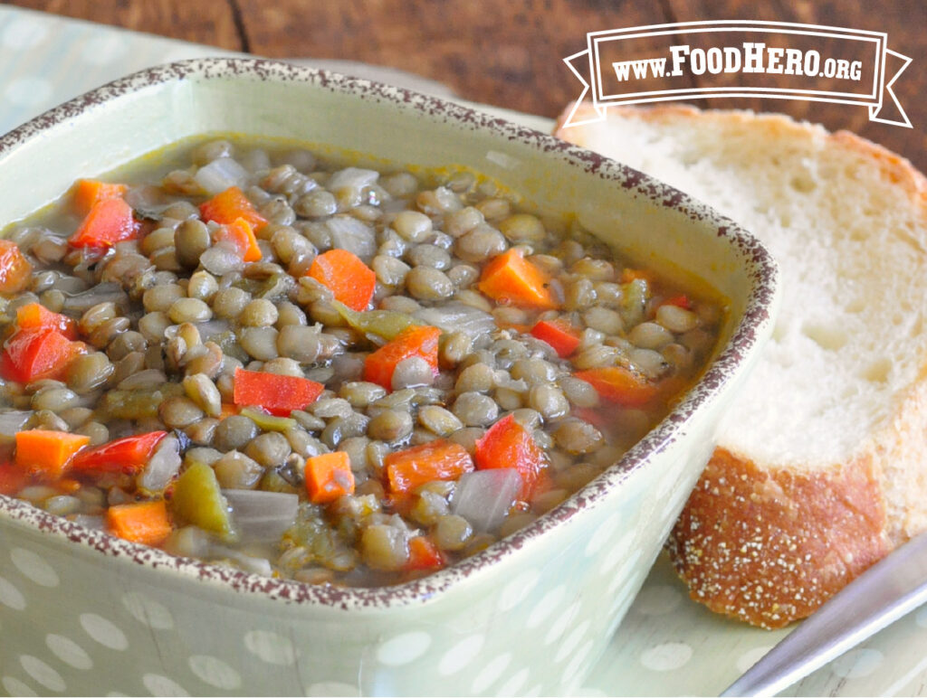bowl of lentil soup with a slice of bread