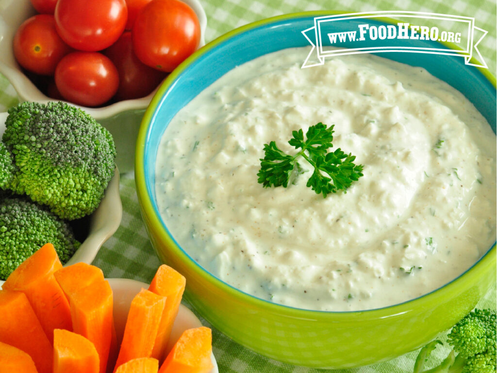 dish of ranch dip with cut carrots and broccoli