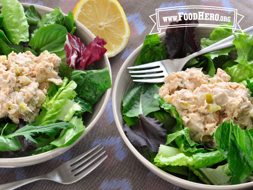 2 bowls of salmon salad mix with forks