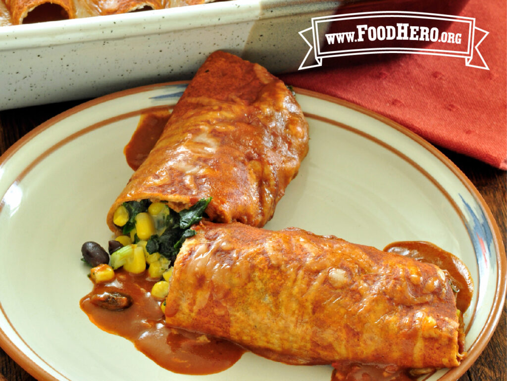 plate with spinach and black bean enchiladas
