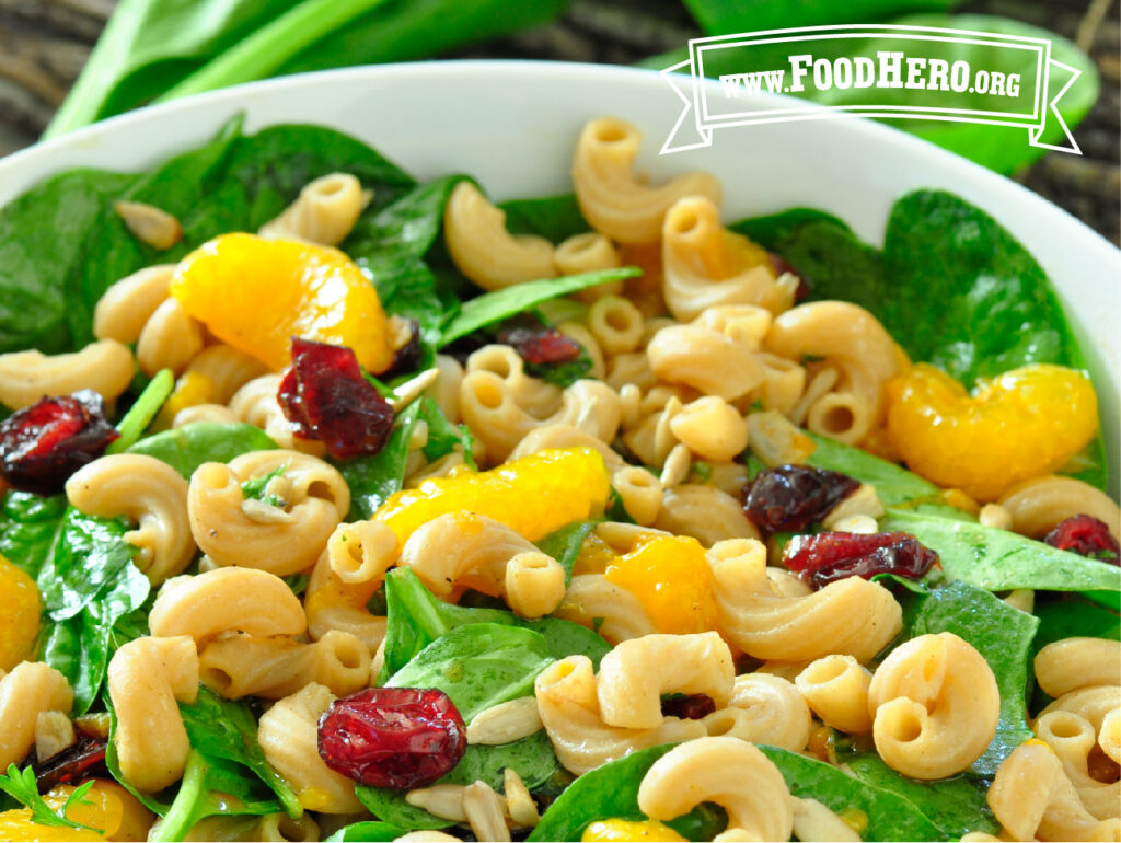 white bowl filled with spinach pasta salad