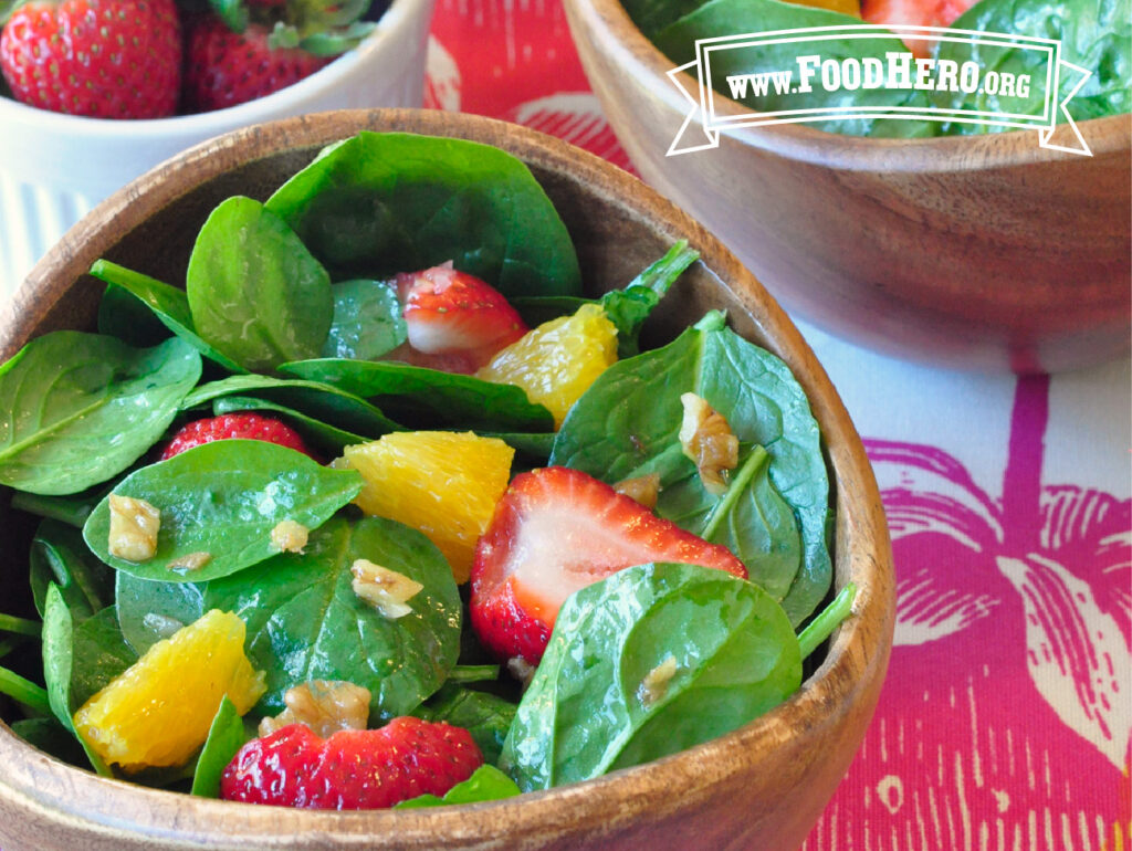 2 wooden bowls of spring green salad