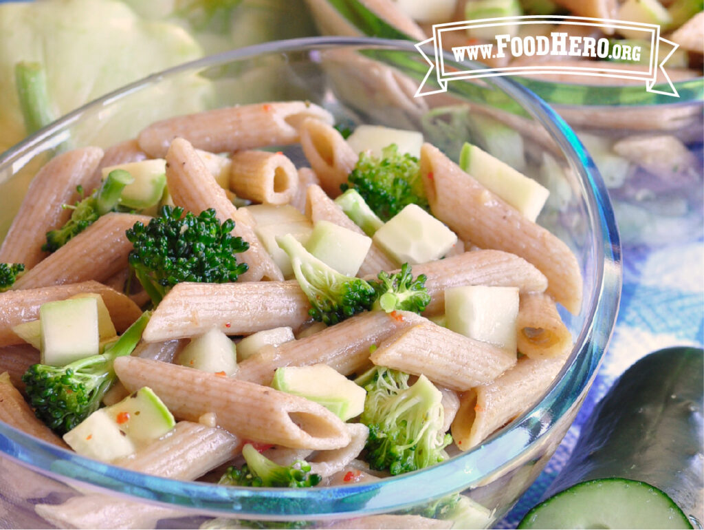 glass bowl of summer vegetable and pasta salad