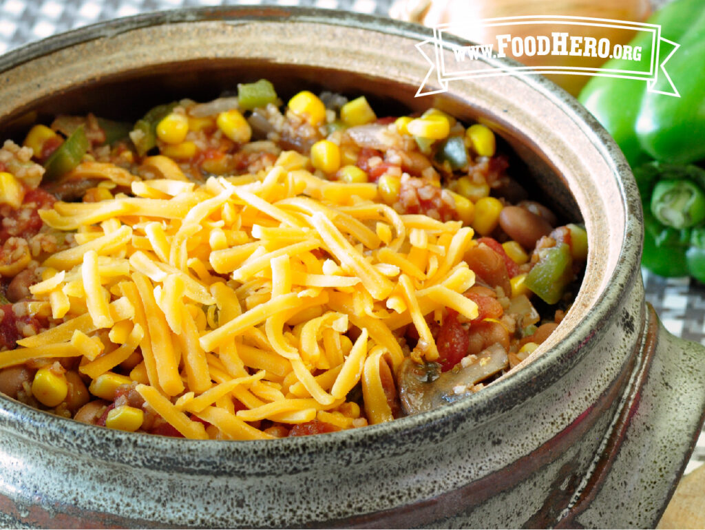 serving bowl of vegetarian  chili topped with shredded cheese