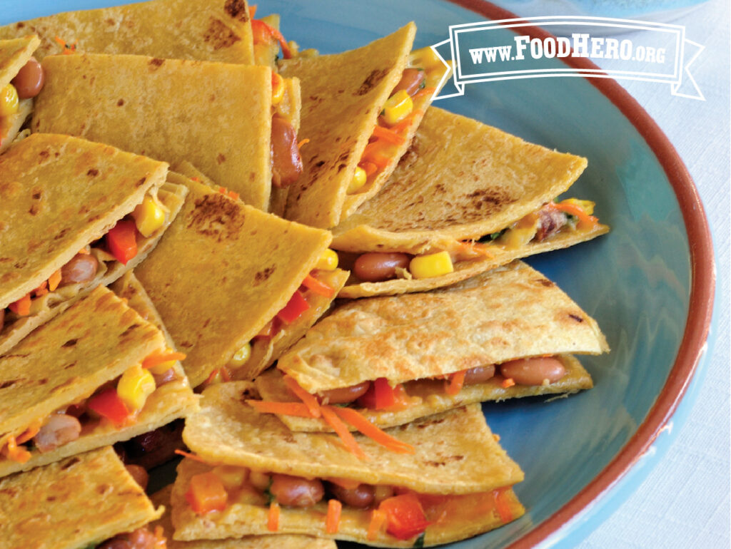 veggie quesadillas with cilantro yogurt dip on a platter