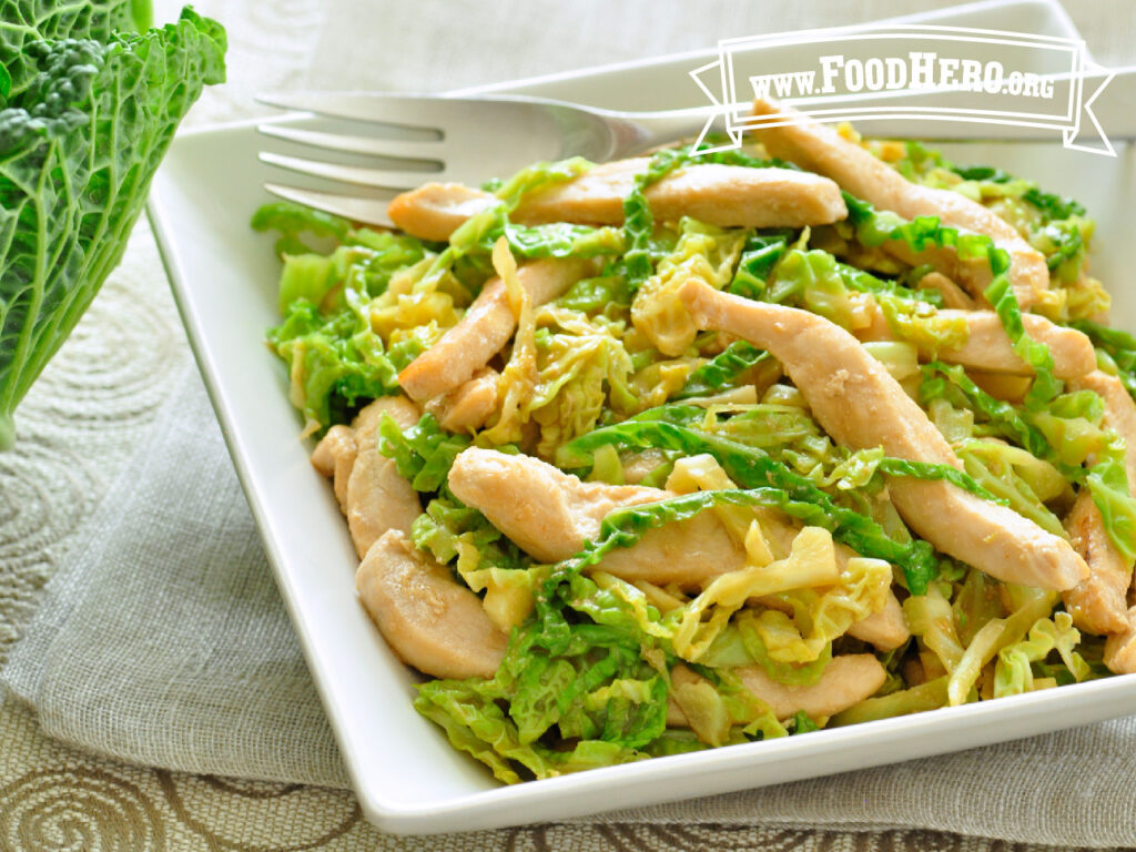 plate of chicken cabbage stir-fry with fork