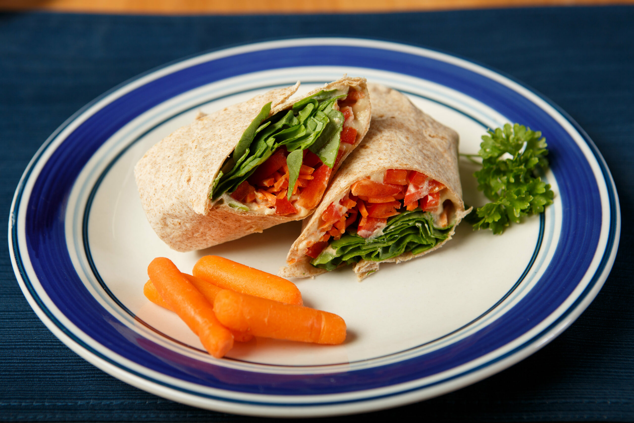 hummus warp on a plate with baby carrots