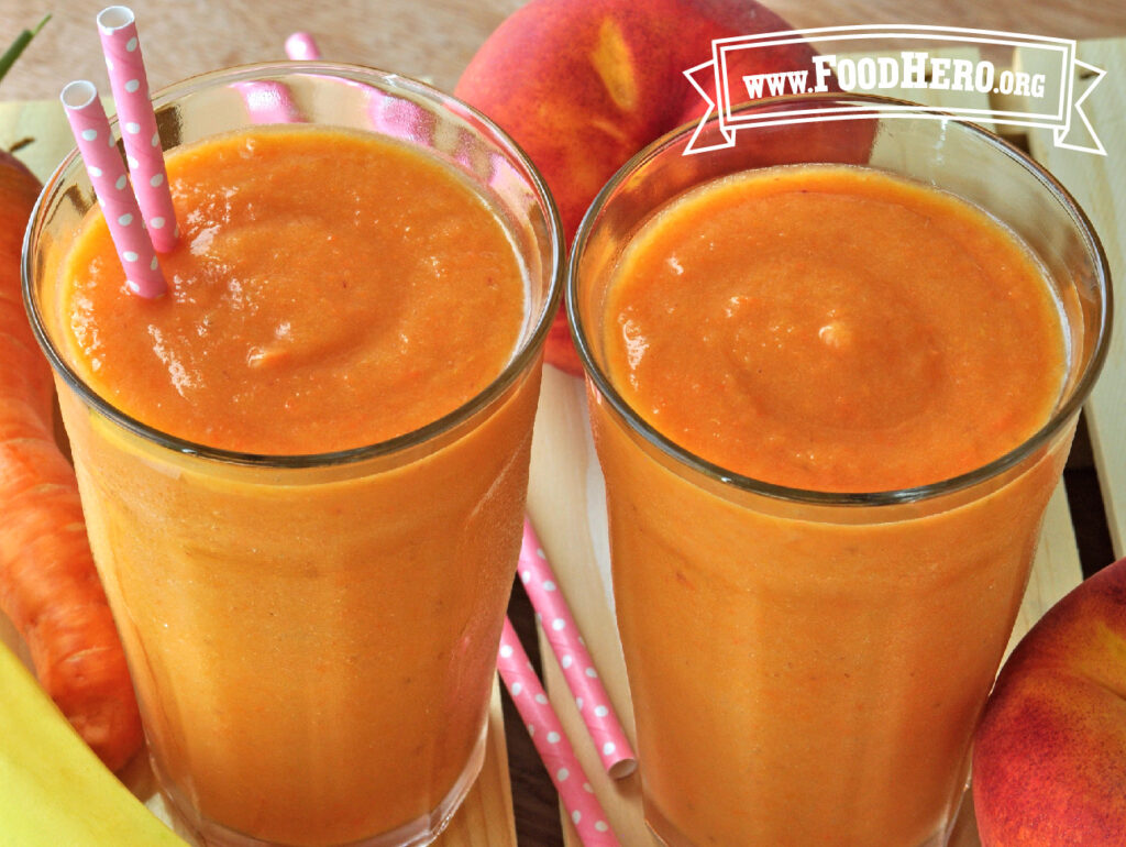 two glasses of peach and carrot smoothies
