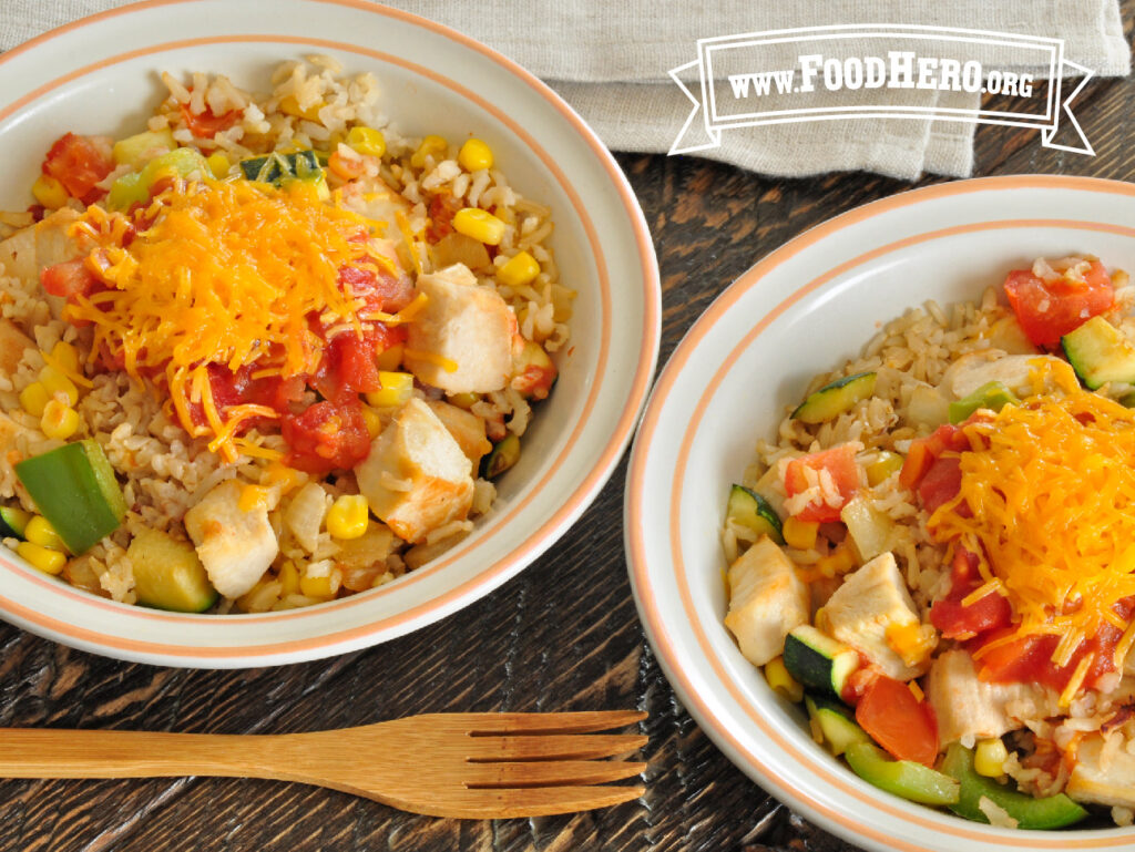 2 bowls of vegetable and chicken rice  with wooden fork