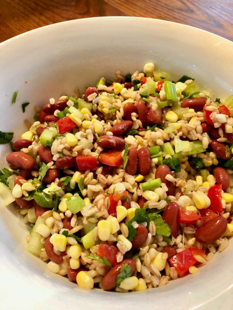 serving bowl of barley, bean and corn salad