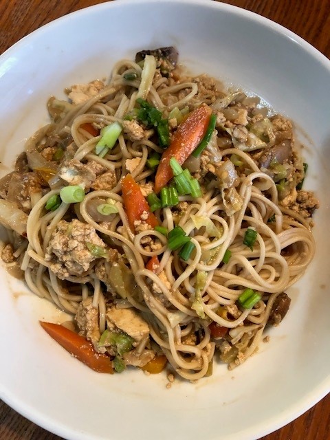 bowl of stir fry noodles with peanut sauce