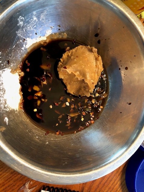 silver bowl with ingredients for peanut sauce